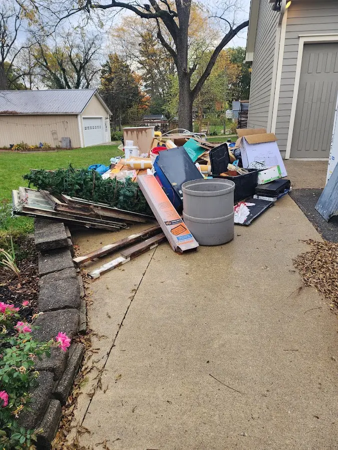 Dumpster being loaded with debris for Estate Cleanout Dumpster Rental in Grovetown